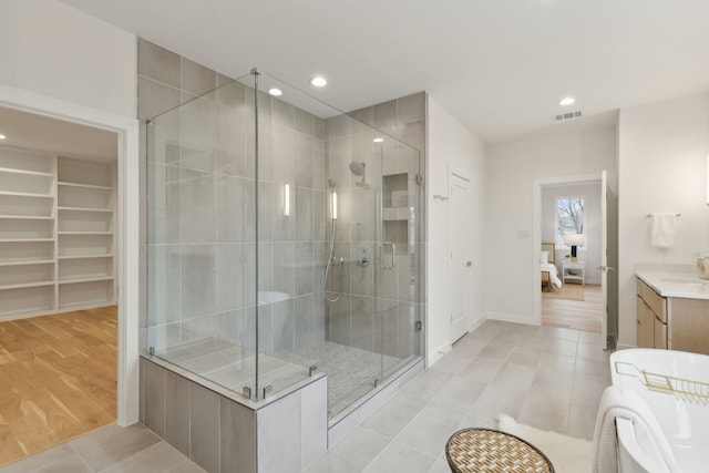 bathroom featuring recessed lighting, visible vents, ensuite bathroom, and a shower stall