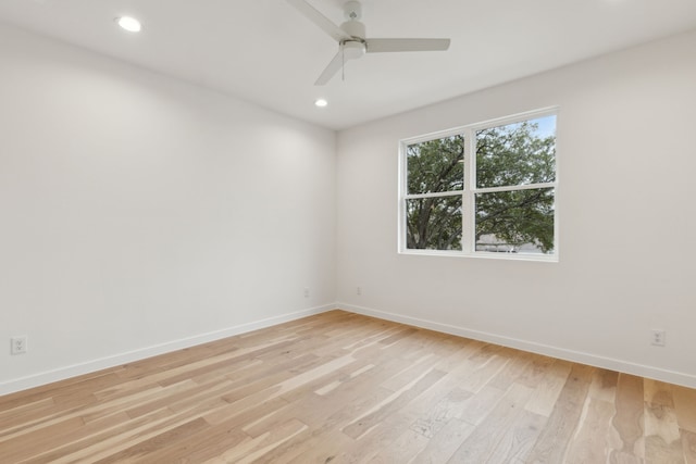 empty room with recessed lighting, baseboards, and light wood-style floors