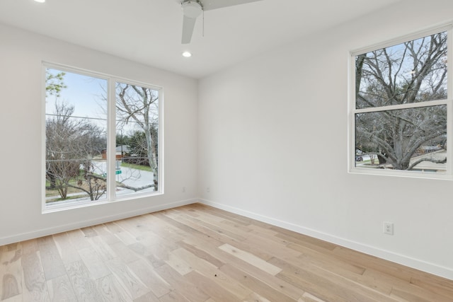 unfurnished room featuring baseboards, a healthy amount of sunlight, and light wood-style flooring