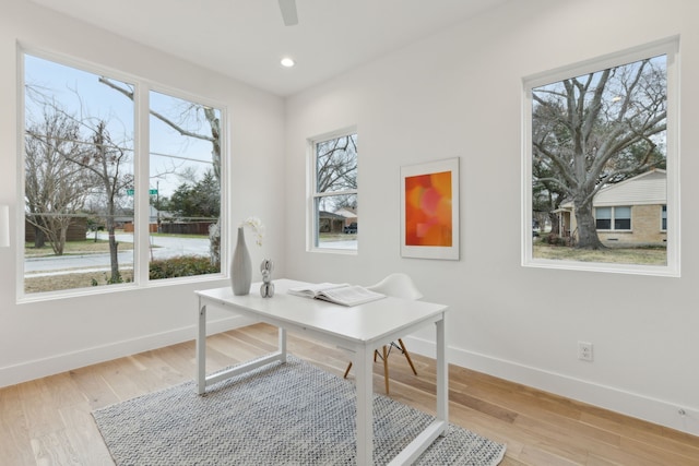 office space featuring recessed lighting, baseboards, ceiling fan, and light wood finished floors