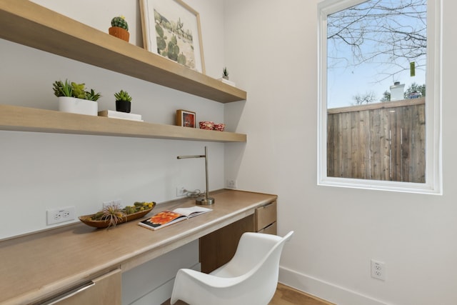 office featuring baseboards and built in desk