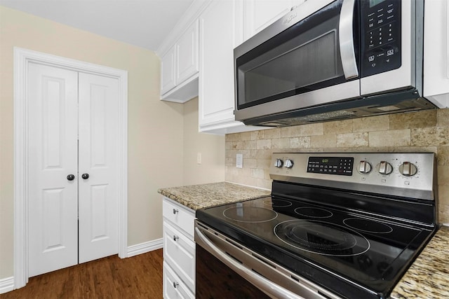 kitchen with baseboards, decorative backsplash, stainless steel appliances, dark wood-style floors, and white cabinetry