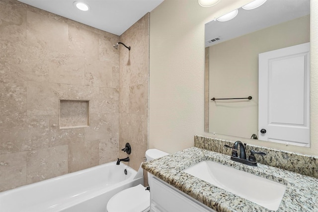 bathroom featuring vanity, bathing tub / shower combination, toilet, and visible vents