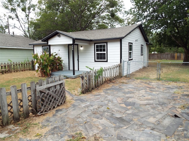 single story home featuring a gate and fence