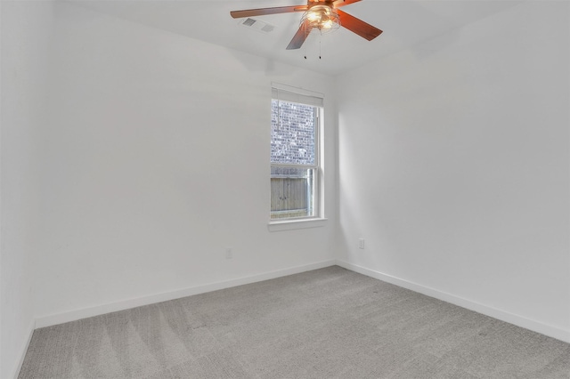 empty room with visible vents, light carpet, baseboards, and ceiling fan