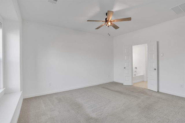 unfurnished bedroom with visible vents, ceiling fan, baseboards, carpet floors, and ensuite bath