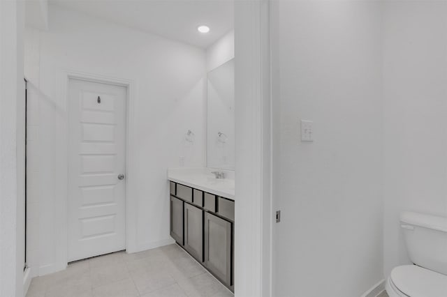 full bath with vanity, tile patterned floors, toilet, and baseboards