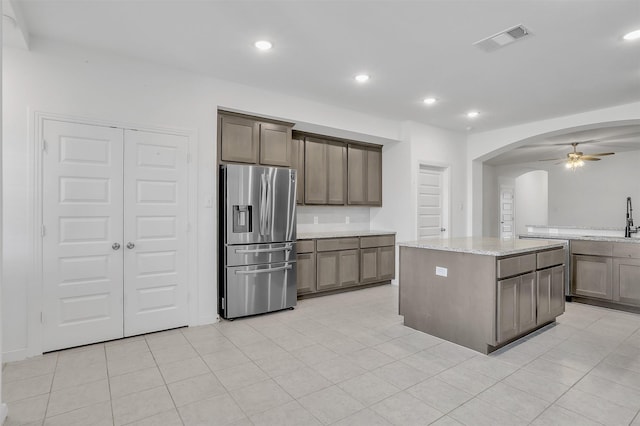 3917 Spencer Ln, Heartland, TX 75126 - kitchen with stainless steel refrigerator with ice dispenser, arched walkways, a sink, a ceiling fan, and recessed lighting