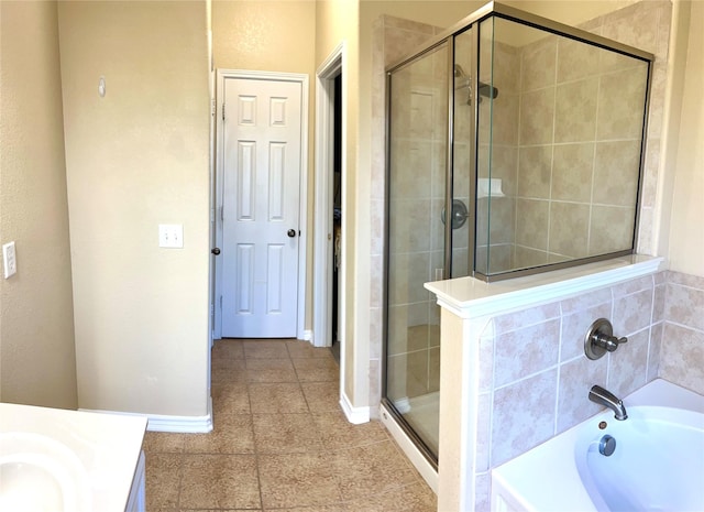 bathroom featuring a shower stall, a bath, baseboards, and tile patterned floors