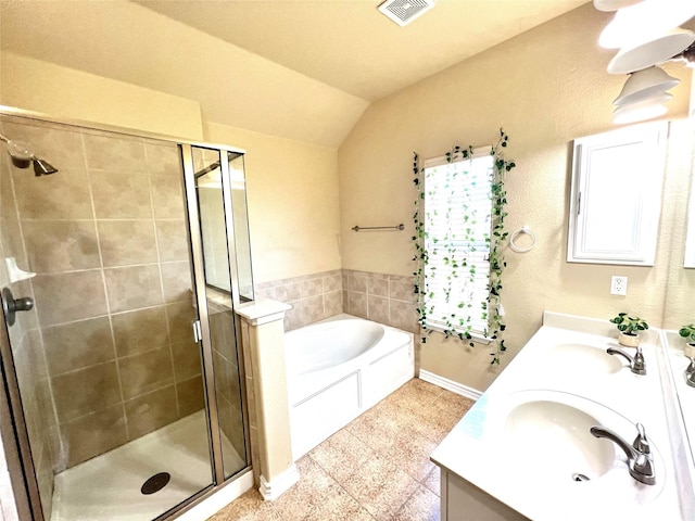 bathroom featuring double vanity, visible vents, a stall shower, and a sink