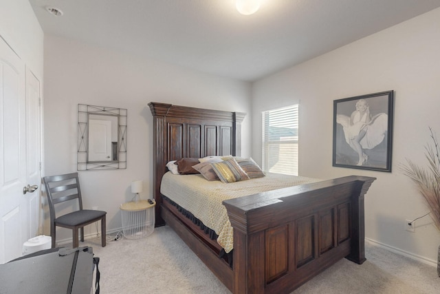 bedroom featuring baseboards and light carpet