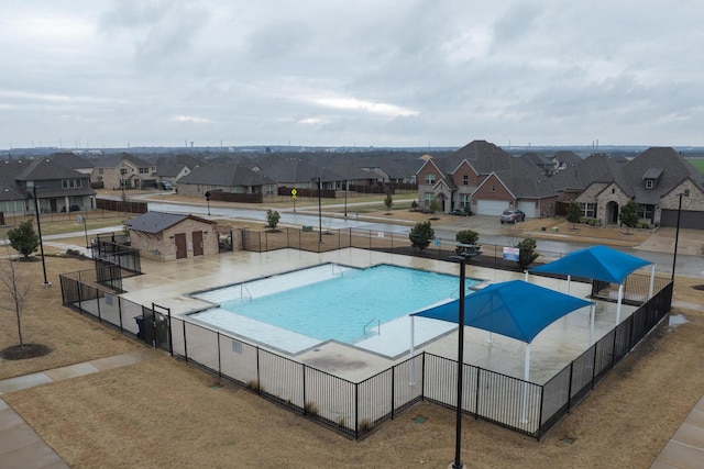 pool featuring a residential view and fence