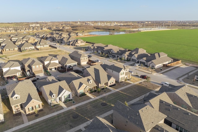 drone / aerial view with a water view and a residential view