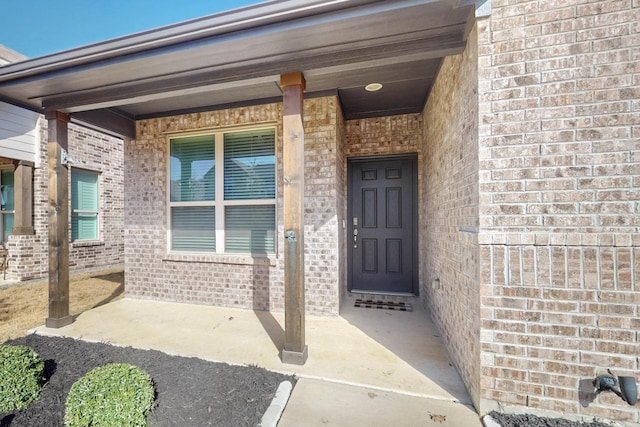 property entrance with brick siding