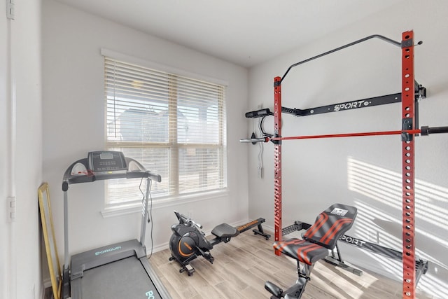 exercise room with wood finished floors