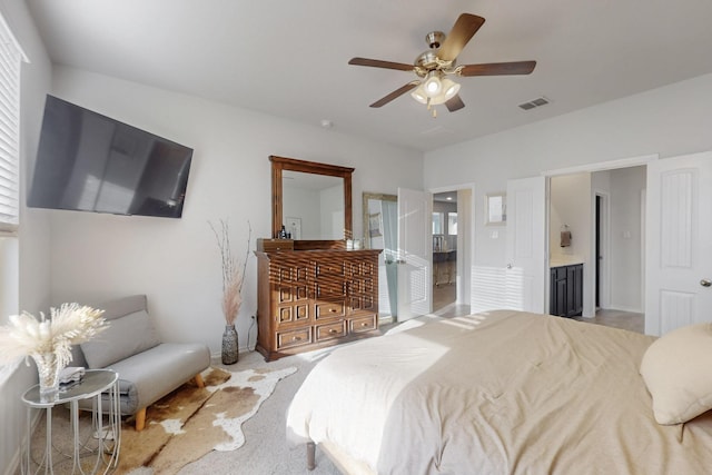 carpeted bedroom with ensuite bath, a ceiling fan, and visible vents