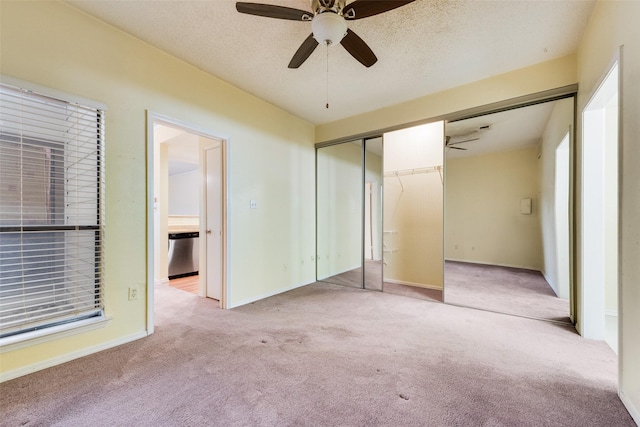 unfurnished bedroom featuring a textured ceiling, a closet, carpet, baseboards, and ceiling fan