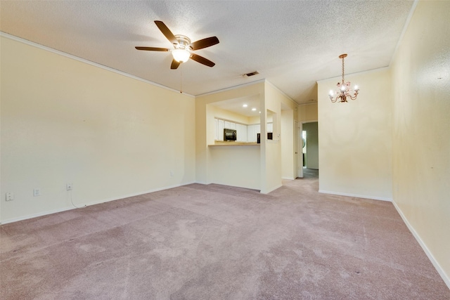 spare room featuring light colored carpet, visible vents, a textured ceiling, and crown molding