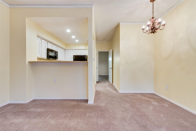 kitchen featuring baseboards, black appliances, light carpet, white cabinetry, and crown molding