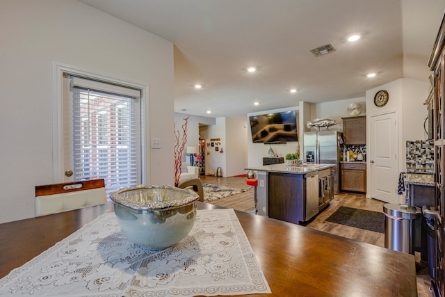 kitchen featuring light wood-type flooring, visible vents, a kitchen island, and recessed lighting