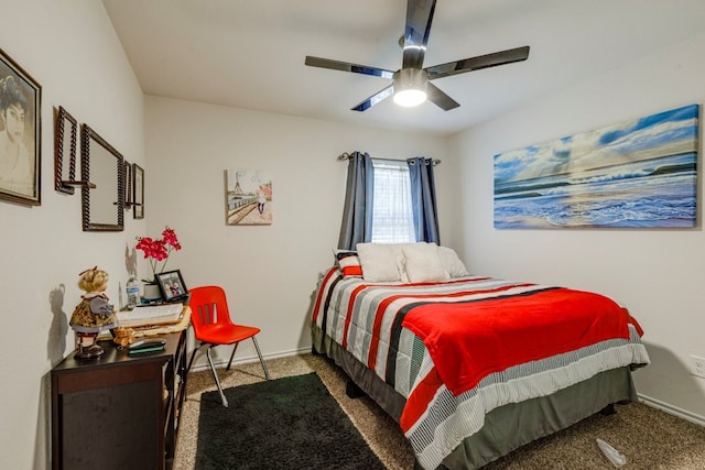 carpeted bedroom with ceiling fan and baseboards