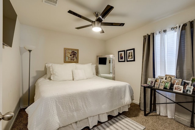 carpeted bedroom with visible vents and ceiling fan