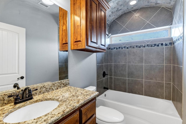 bathroom with vanity, toilet, bathtub / shower combination, and visible vents