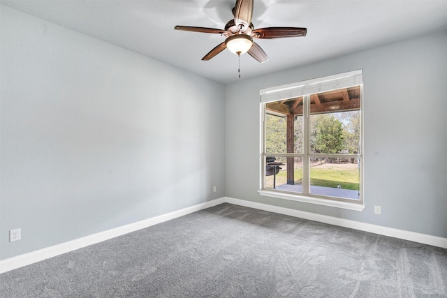 unfurnished room featuring baseboards, ceiling fan, and dark carpet