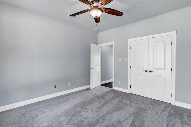 unfurnished bedroom with carpet, visible vents, a closet, and baseboards