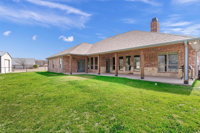 back of property featuring brick siding, a chimney, and a shingled roof