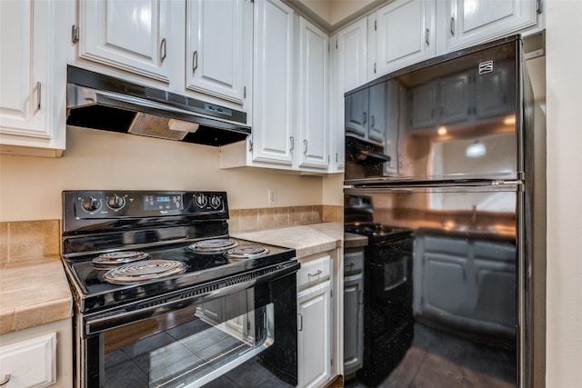 4034 Rawlins St Unit 102, Dallas, TX 75219 - kitchen with black appliances, under cabinet range hood, and white cabinetry