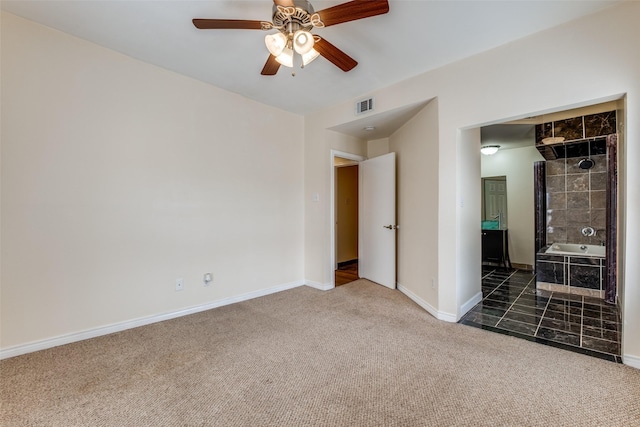 4034 Rawlins St Unit 102, Dallas, TX 75219 - unfurnished bedroom featuring carpet, baseboards, and a ceiling fan
