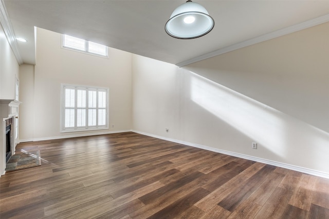 4034 Rawlins St Unit 102, Dallas, TX 75219 - unfurnished living room with dark wood-style flooring, a fireplace, and baseboards