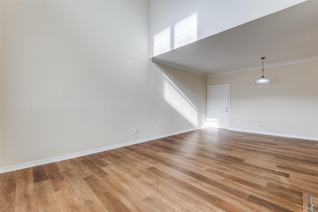 4034 Rawlins St Unit 102, Dallas, TX 75219 - spare room with crown molding, light wood-style floors, and baseboards