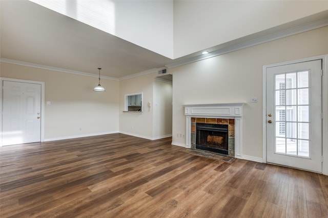 4034 Rawlins St Unit 102, Dallas, TX 75219 - unfurnished living room featuring crown molding, wood finished floors, plenty of natural light, and baseboards