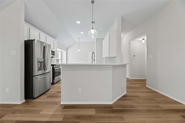 kitchen featuring hanging light fixtures, light countertops, appliances with stainless steel finishes, white cabinetry, and light wood-type flooring