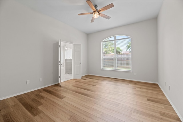 empty room featuring baseboards, light wood finished floors, and ceiling fan