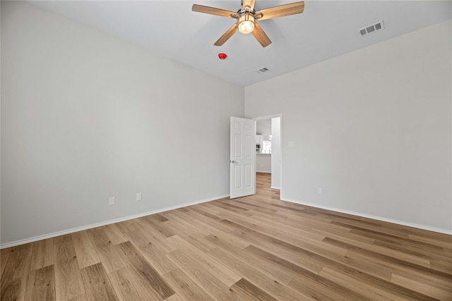 unfurnished room featuring visible vents, baseboards, light wood-style floors, and a ceiling fan