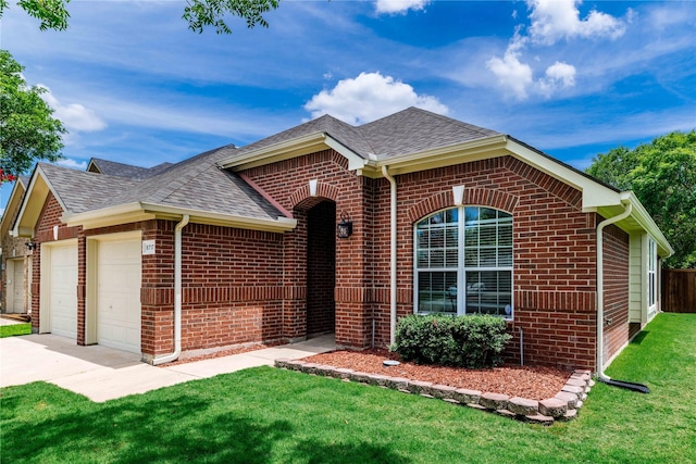 ranch-style home featuring a front yard, an attached garage, brick siding, and a shingled roof