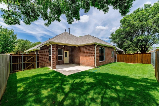 rear view of property featuring a gate, a yard, a fenced backyard, a patio area, and brick siding