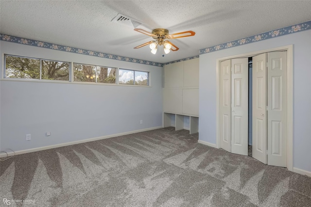 unfurnished bedroom with baseboards, visible vents, carpet floors, a closet, and a textured ceiling