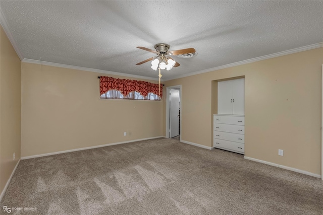 unfurnished bedroom featuring baseboards, a textured ceiling, ornamental molding, and carpet flooring