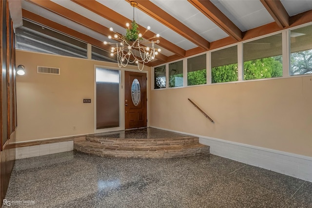 entryway with lofted ceiling with beams, visible vents, a notable chandelier, and granite finish floor