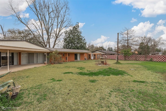 view of yard with a patio and fence