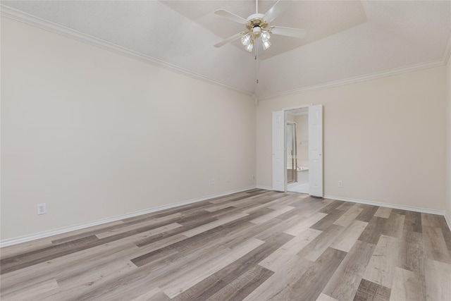 unfurnished room with ornamental molding, light wood finished floors, baseboards, ceiling fan, and vaulted ceiling