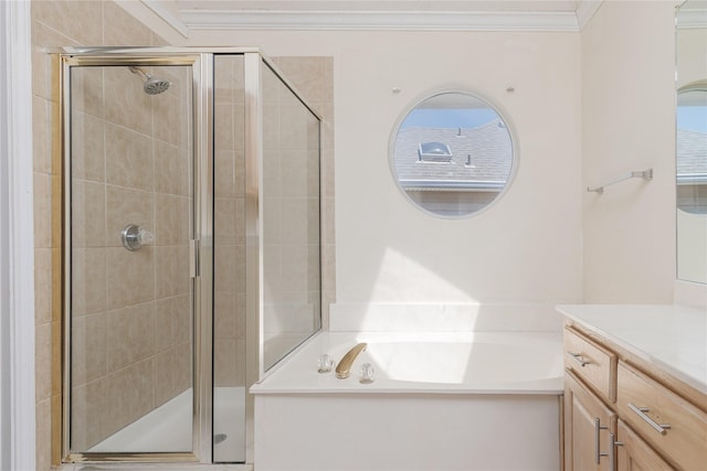 bathroom with vanity, a garden tub, a stall shower, and crown molding