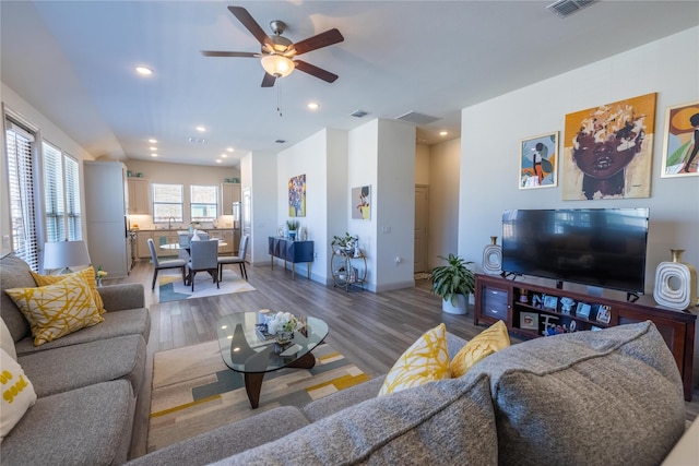 living room with visible vents, baseboards, recessed lighting, wood finished floors, and a ceiling fan