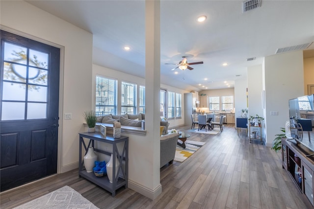 living room featuring recessed lighting, visible vents, and wood finished floors