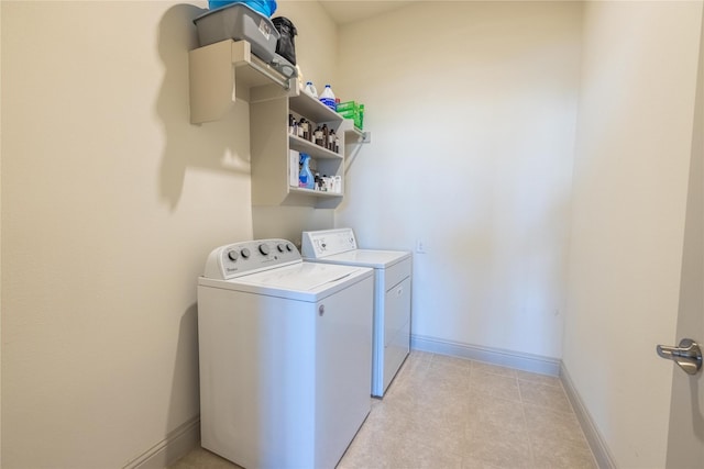 laundry area featuring baseboards, laundry area, and washer and clothes dryer