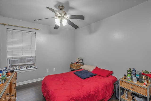 bedroom with a ceiling fan, wood finished floors, and baseboards